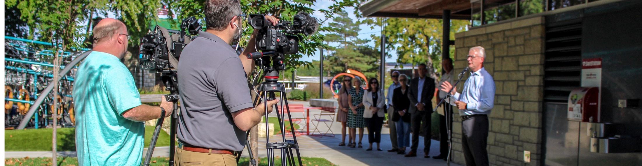 Public speaking in park with cameras